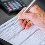 A man filling out a pension claim form